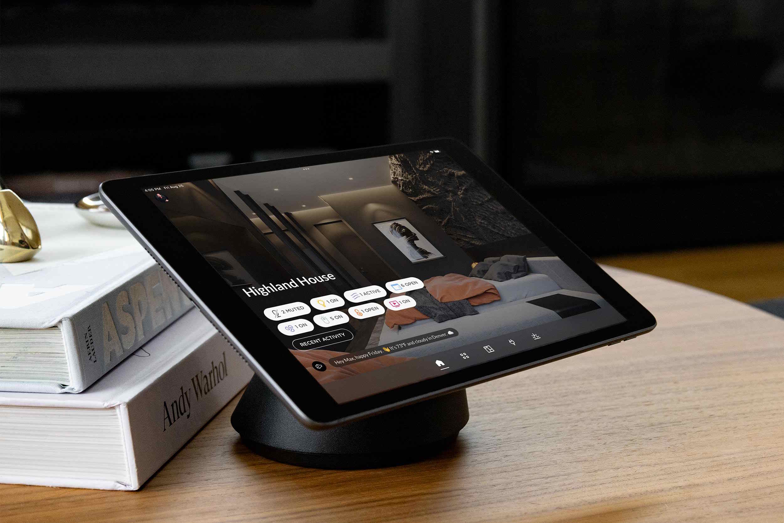 Tablet on a stand displaying a smart home control dashboard