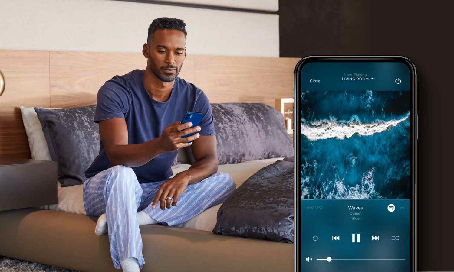 Man streaming music to his living room using a multi-room audio app on his phone