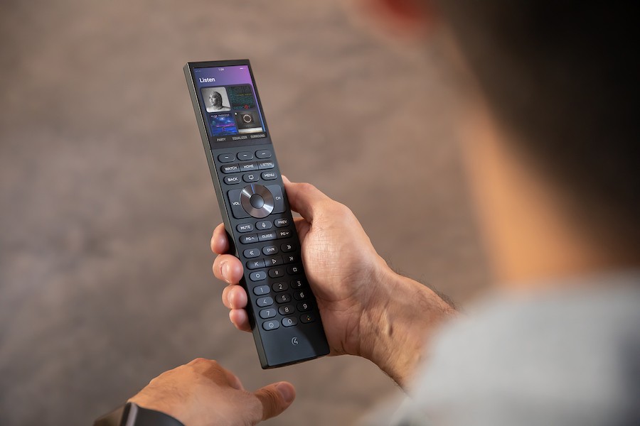  A homeowners holding his Control4 universal remote. 