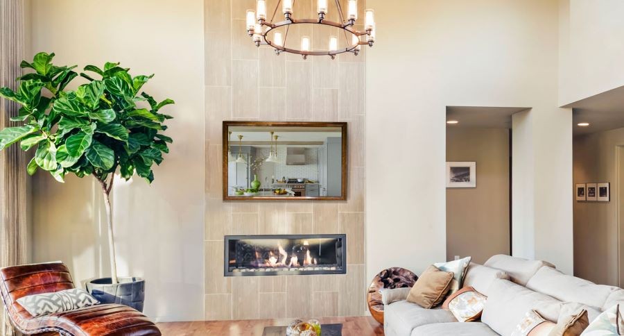 A Seura TV mirror above a modern fireplace in a living room.
