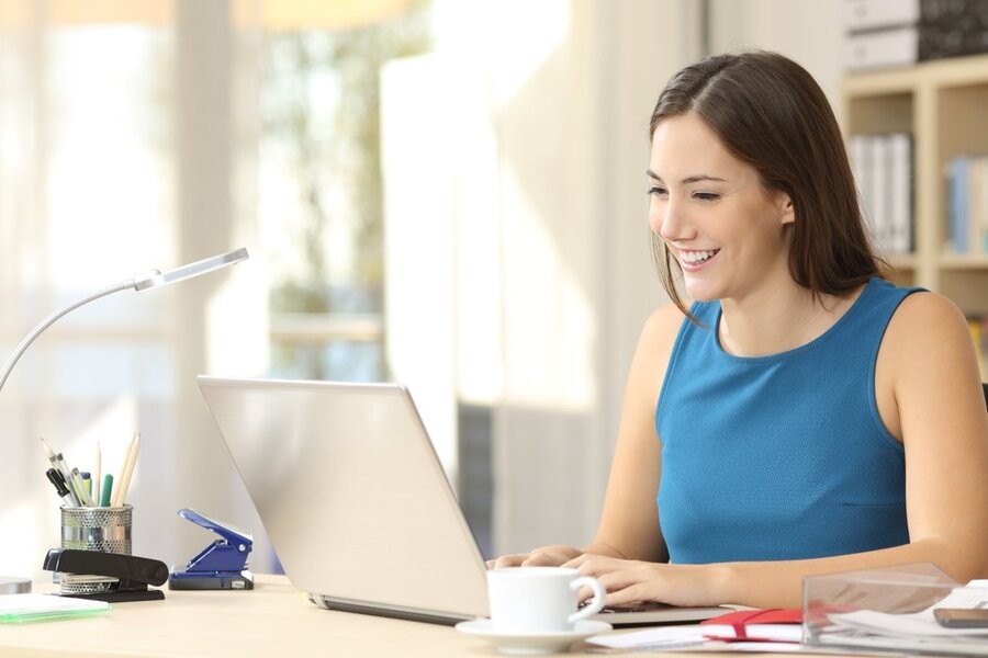  A woman at a desk in her home office utilizing a professional home network installation