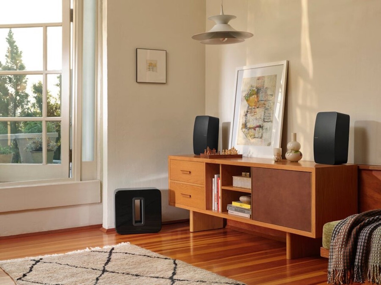  A living space with a table featuring two Sonos speakers.