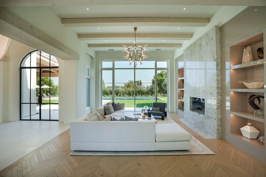 A living area with Sonance Invisible Series speakers and a view of the pool.