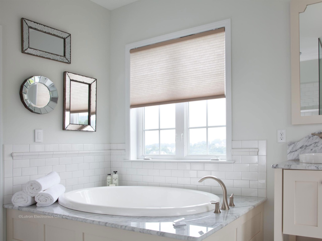 Lutron lighting system installed in a luxury bathroom with a modern bathtub