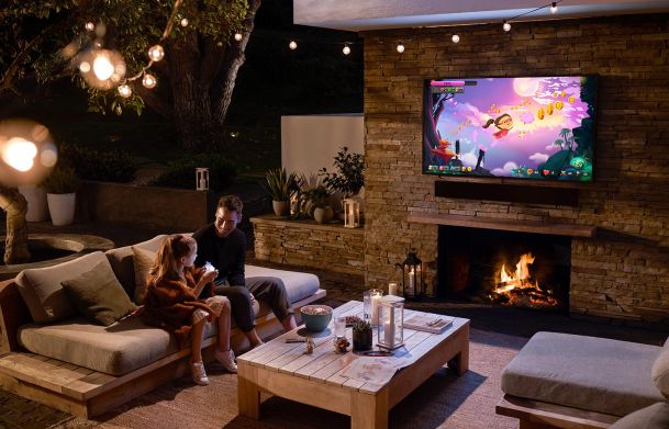 Girl and father enjoying Sony outdoor entertainment